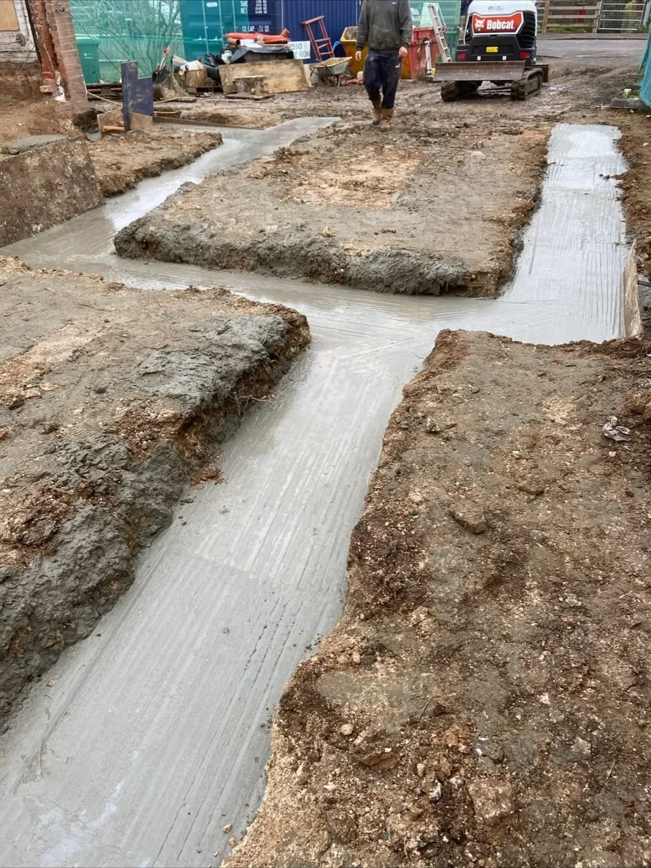 Groundworks excavator preparing foundation trenches