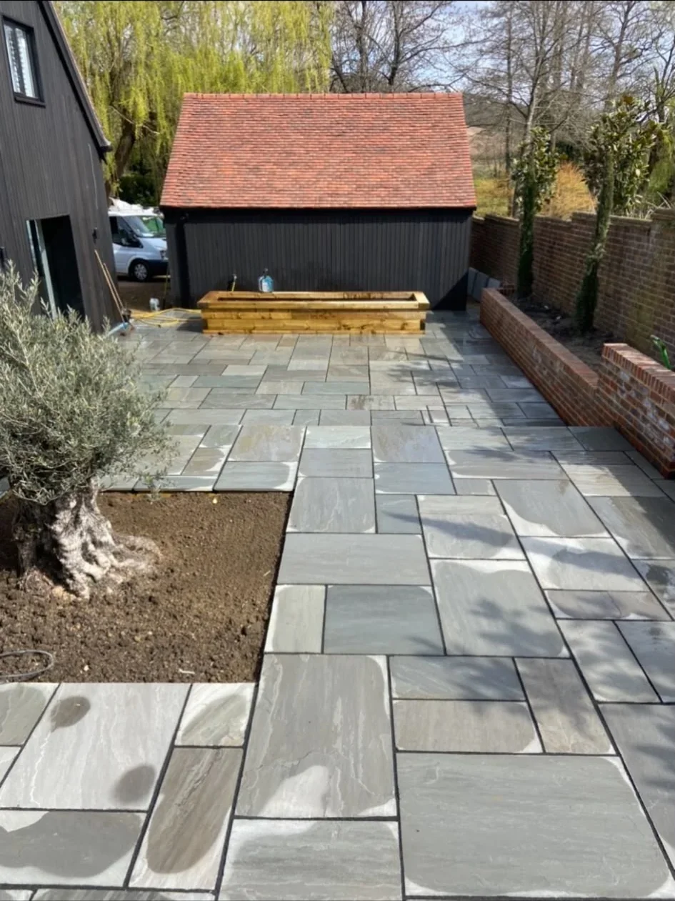 Large format sandstone patio and garden building